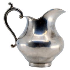 Smooth, rounded silver water jug