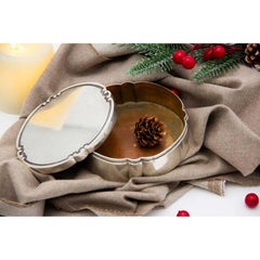 Smooth silver box in a circular shape with a strip on the removable lid