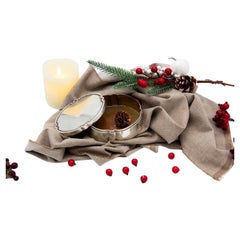 Smooth silver box in a circular shape with a strip on the removable lid