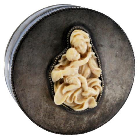 Smooth silver box w/ a circular shape & pearly edges, w/ a lady & boy on the lid For Sale