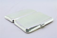 Smooth silver cigarette case with a curved shape and a spring-loaded hinged lid
