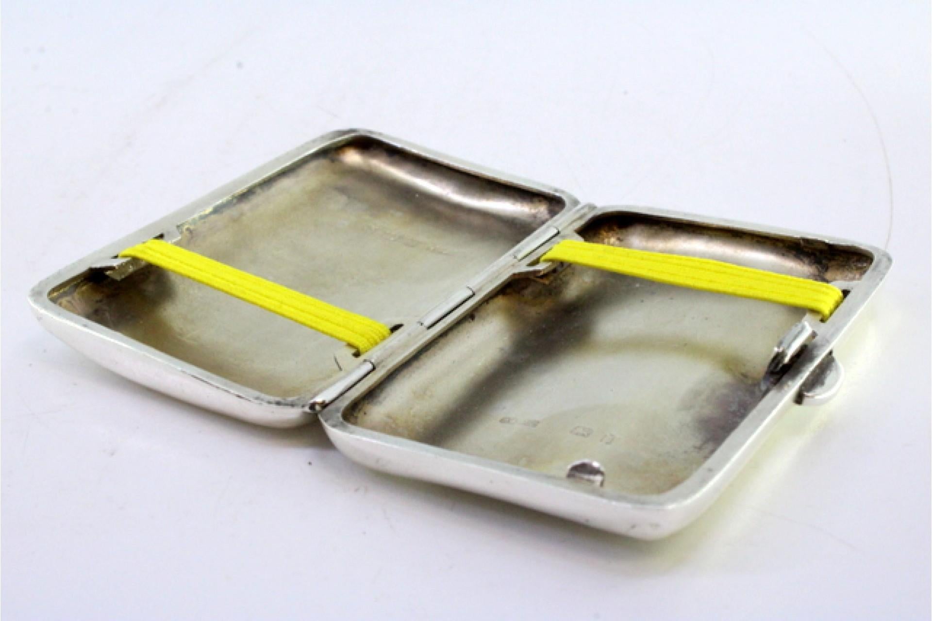 European Smooth silver cigarette case with a curved shape and a spring-loaded hinged lid For Sale