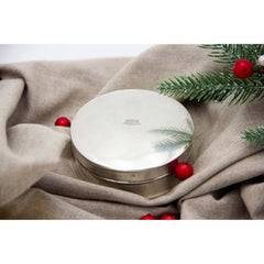 Smooth silver circular box with crown engraved on the removable lid