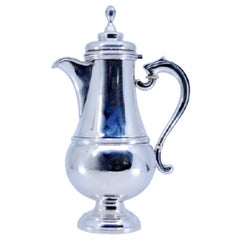 Smooth silver coffee maker with raised handle and knob lid