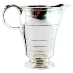 Antique Smooth silver creamer with border trim & circular base