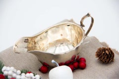 Smooth silver creamer with scalloped rim, appliqué handle and set on four feet