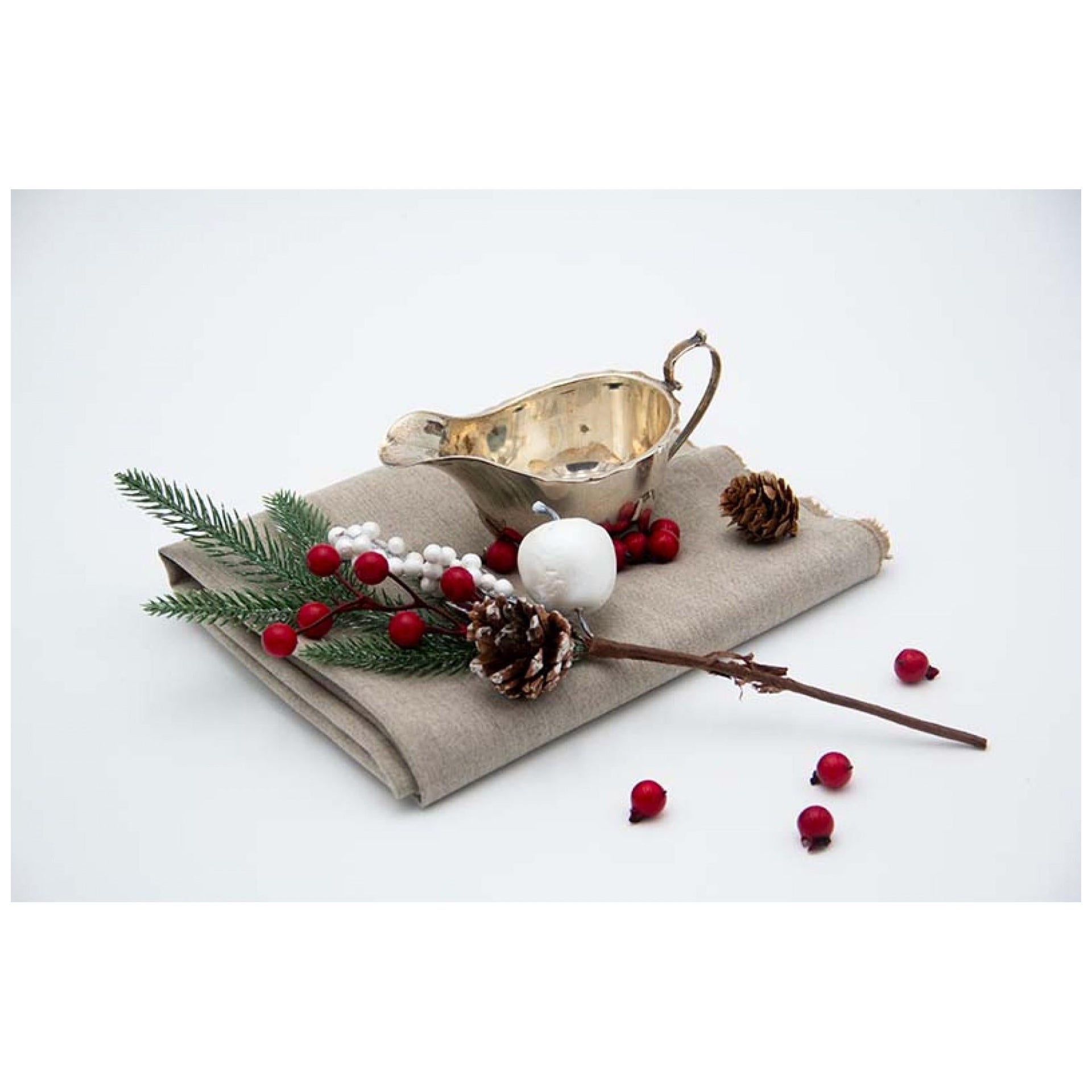 Smooth silver creamer with scalloped rim, appliqué handle and set on four feet