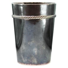 Smooth silver cup with a frieze revealed on the edge