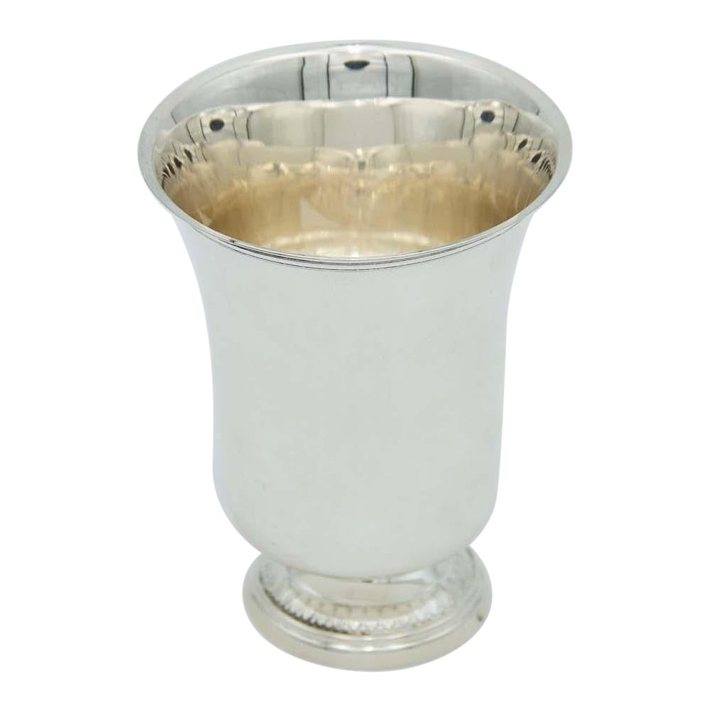 Smooth silver cup with circular relief base and frieze