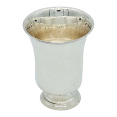 Smooth silver cup with circular relief base and frieze