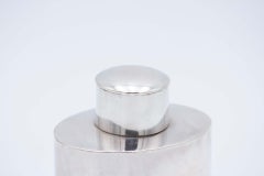 Smooth silver elliptical talcum powder bottle