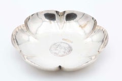 Smooth silver flower-shaped fruit bowl with Swiss coin