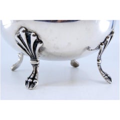 Smooth silver jug, beaded on the rim and resting on three claw-shaped feet