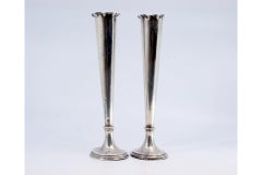 Smooth silver jugs with wavy edges and fillings at the bases