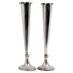 Smooth silver jugs with wavy edges and fillings at the bases