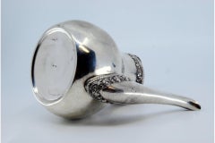 Smooth silver kettle with grooved rim and spout, raised handle and lid knob