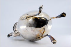 Smooth silver kettle with palms, animal-head spout and tripod form