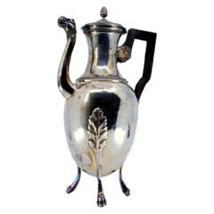 Smooth silver kettle with palms, animal-head spout and tripod form