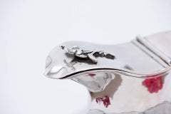 Smooth silver milk jug w/ surrounding trim & floral motifs on the lid as a knob