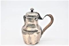 Smooth silver milk jug with straw handle and knob on the hinged lid
