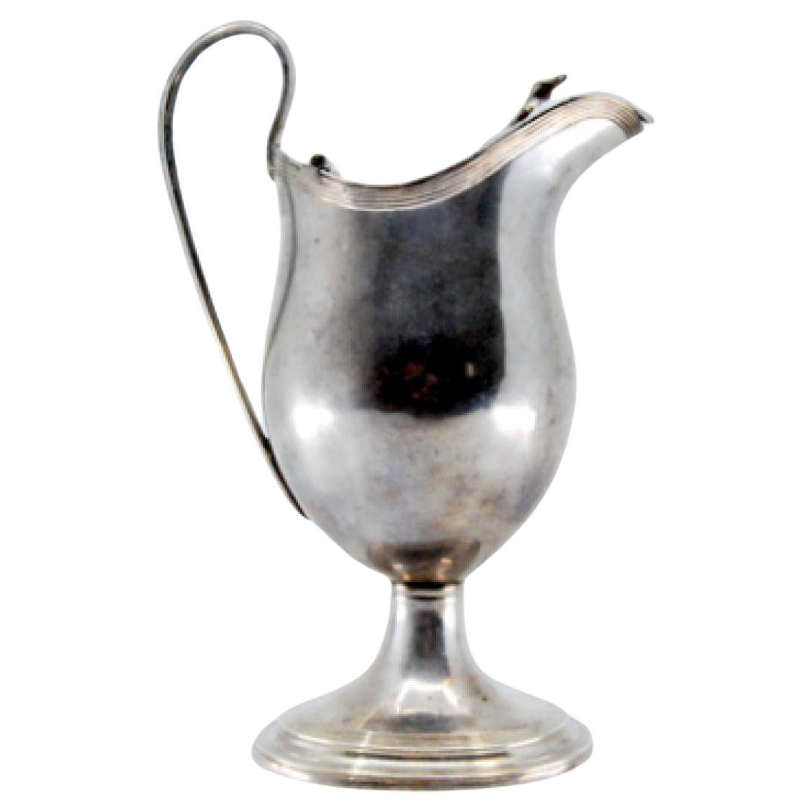 Smooth silver milk jug with strips on the base and knob on the hinged lid For Sale