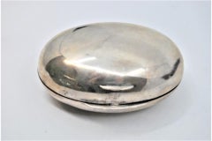 Smooth silver oval-shaped soap dish with a hinged lid
