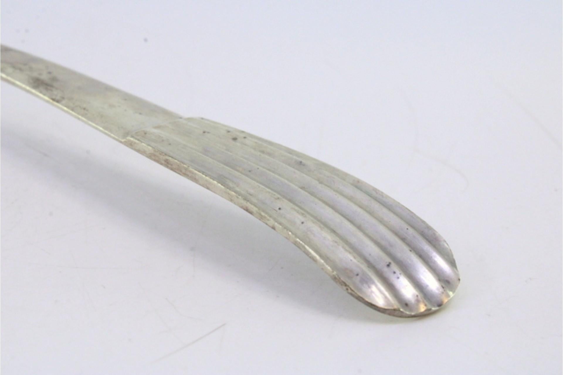 Smooth silver rice/serving spoon with caninhas-style relief handle siglo XX en venta