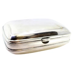 Smooth silver soap dish with appliqué on the clasp, hinged lid and gold interior