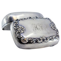 Smooth silver soap dish with embossed floral motifs on the lid