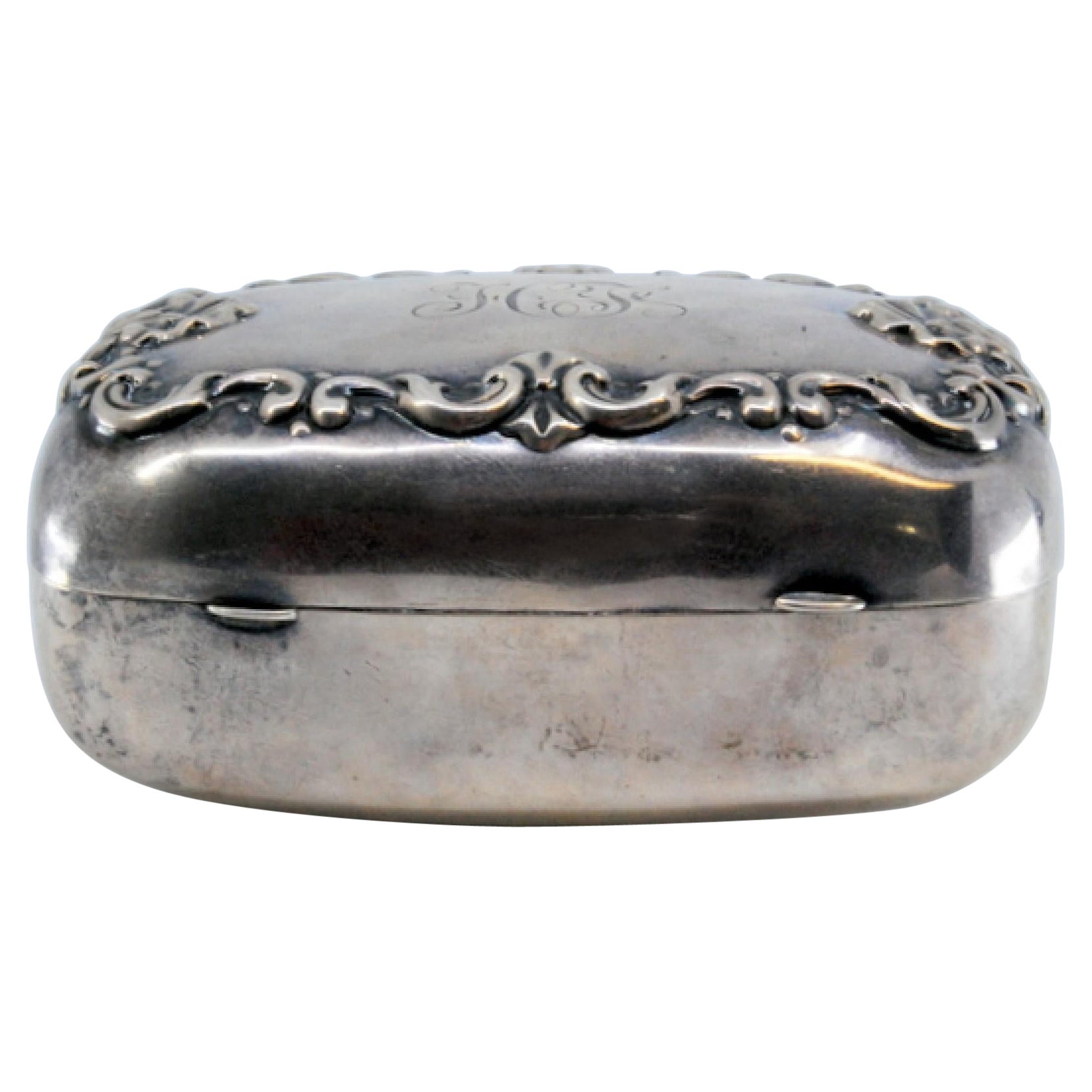 Smooth silver soap dish with embossed floral motifs on the lid