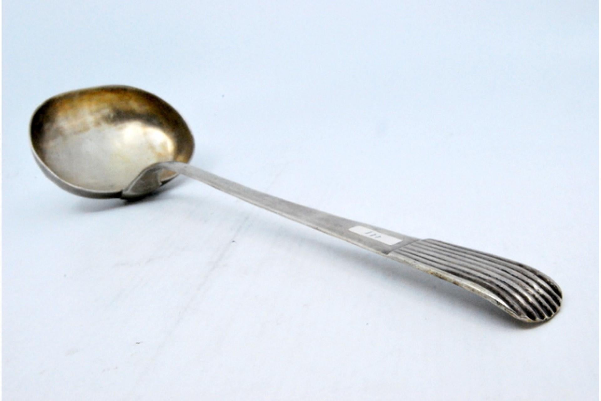 18th Century Smooth silver soup ladle with a raised handle in the reed style For Sale