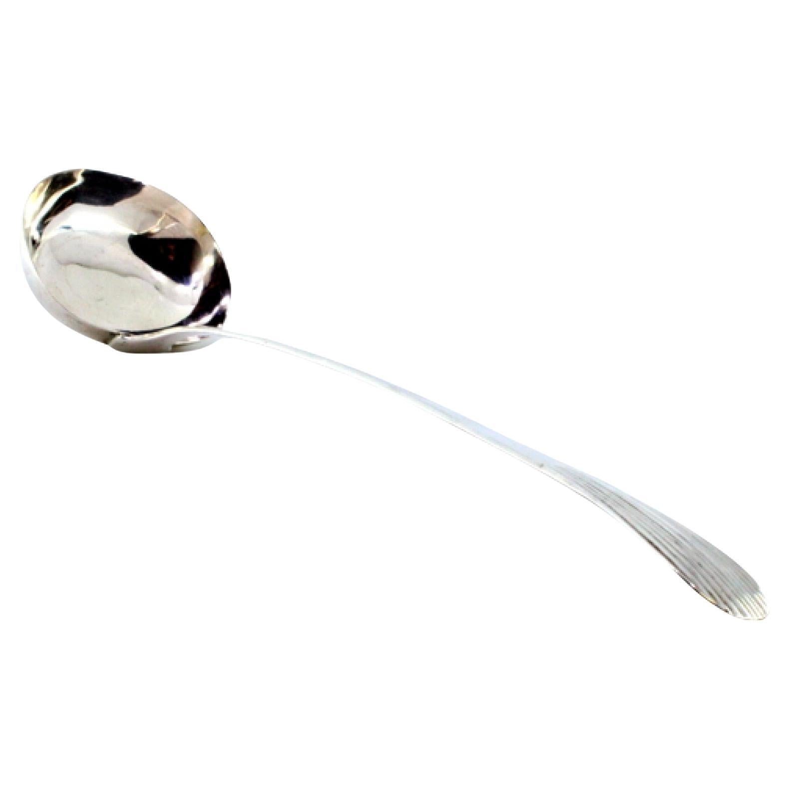 Smooth silver soup ladle with a reed-style handle