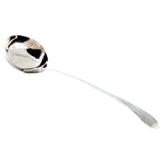 Smooth silver soup ladle with a reed-style handle Smooth silver soup ladle with a reed-style handle