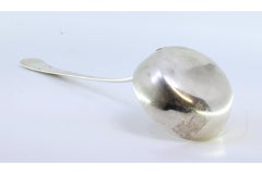 Smooth silver soup ladle with a strip along the handle