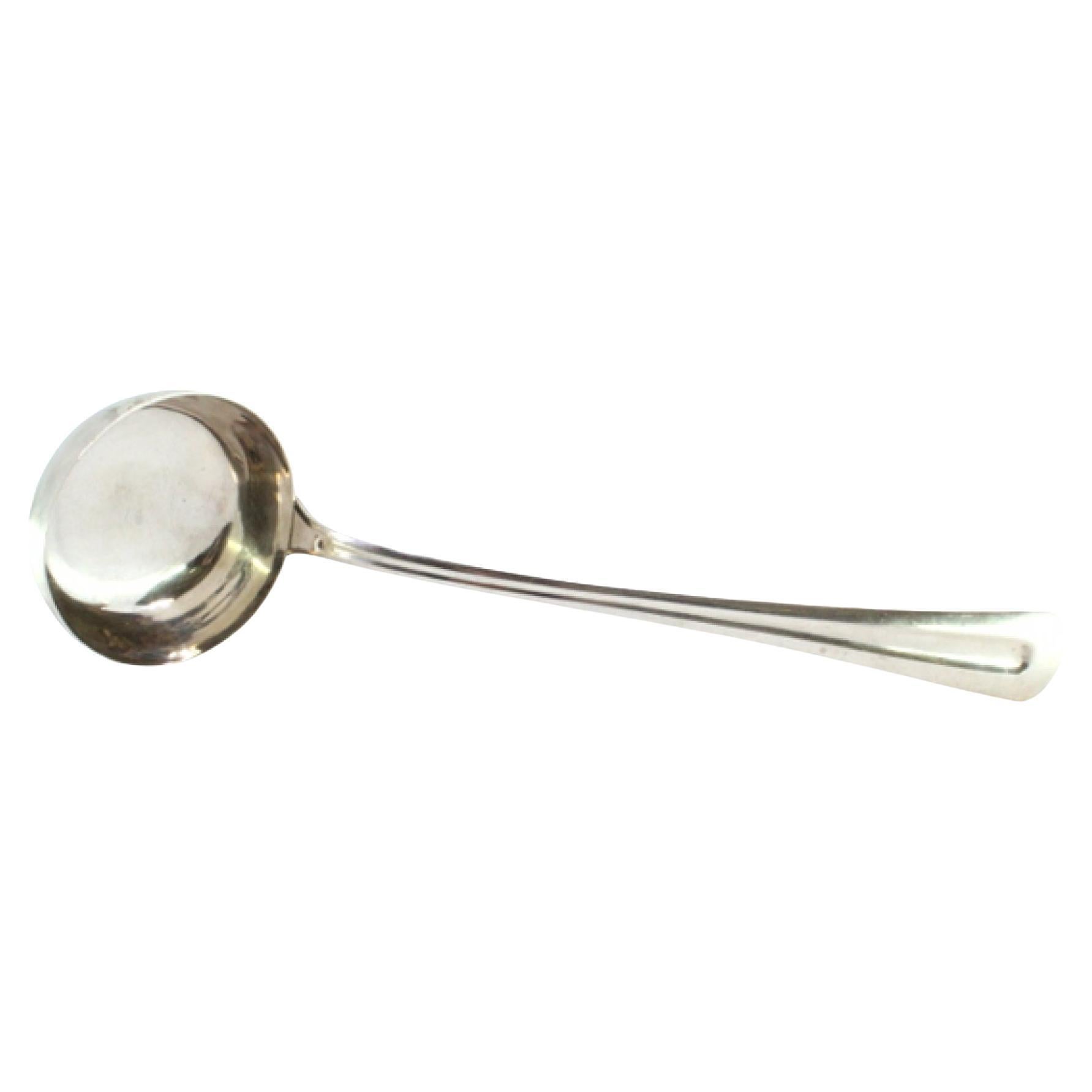 Smooth silver soup ladle with a strip along the handle