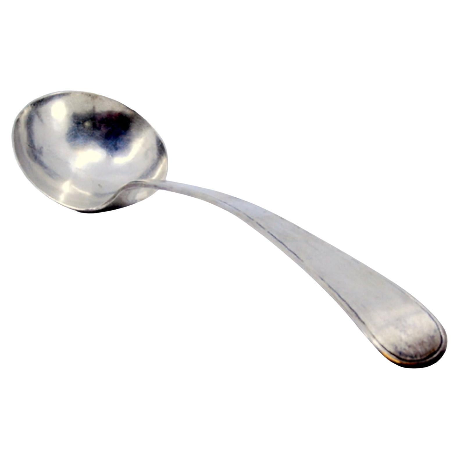 Smooth silver soup ladle with a strip along the handle For Sale