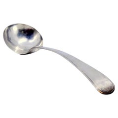 Antique Smooth silver soup ladle with a strip along the handle