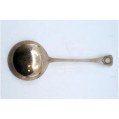 Smooth silver soup ladle with a strip on the handle
