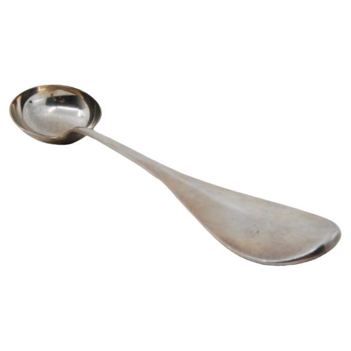 Smooth silver soup ladle with a strip on the handle