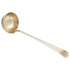Smooth silver soup ladle with a trim on the shell