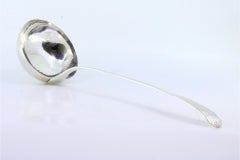 Smooth silver soup ladle with embossed handle