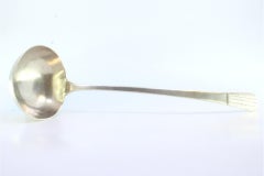 Smooth silver soup ladle with embossed handle