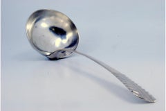 Smooth silver soup ladle with embossed handle