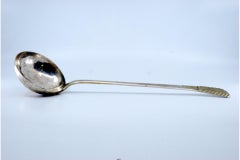Smooth silver soup ladle with embossed handle