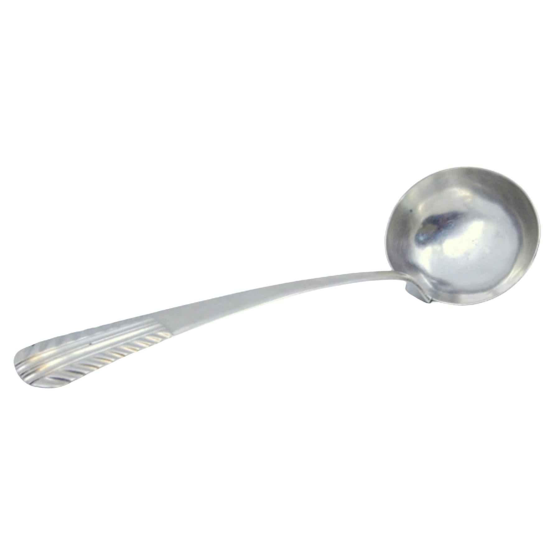 Smooth silver soup ladle with embossed handle