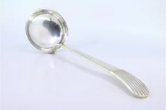 Smooth silver soup ladle with embossed reed-style handle