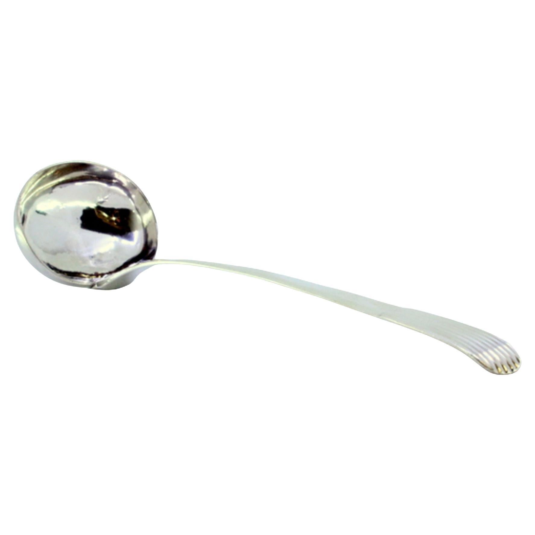 Smooth silver soup ladle with embossed reed-style handle
