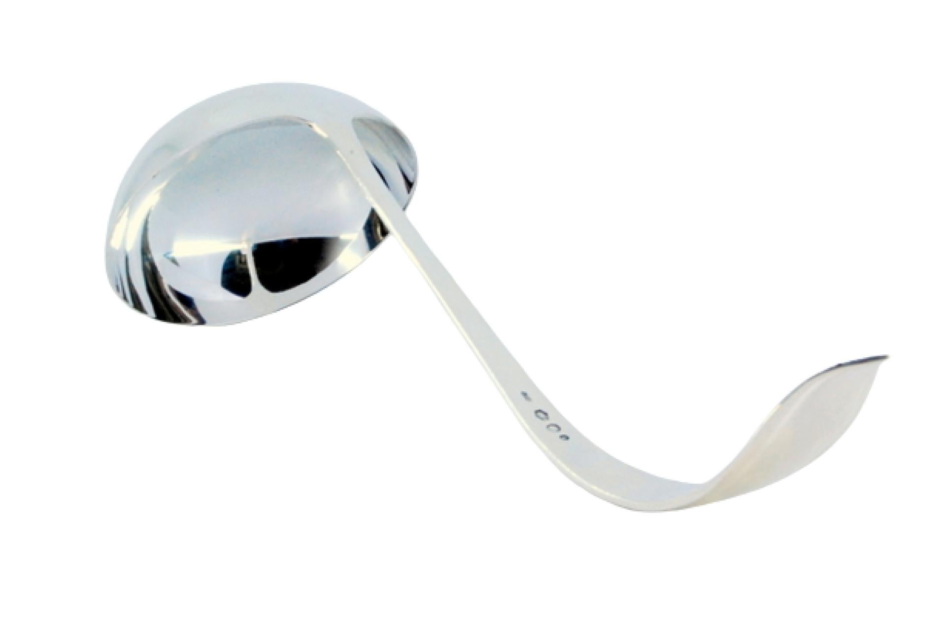 Smooth silver soup ladle with grooves along the curved handle