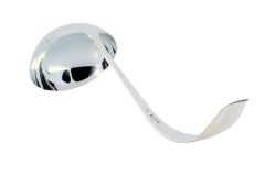 Smooth silver soup ladle with grooves along the curved handle