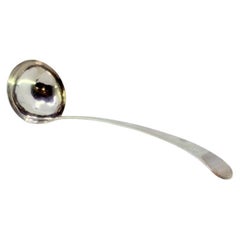 Smooth silver soup ladle with grooves along the handle